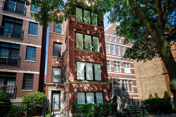 Front view of a multi-story brick apartment building.
