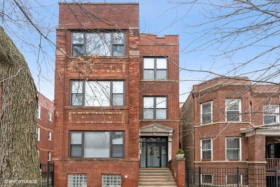 Front view of a three-story brick apartment building.