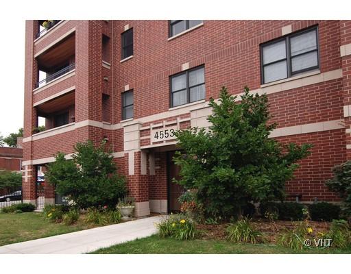 Front view of a multi-story brick building with balconies.