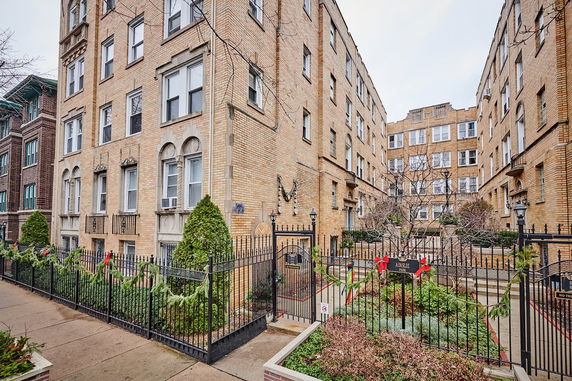 Front view of a multi-story brick apartment building.