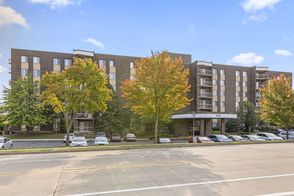 Front view of a multi-story residential building with balconies.
