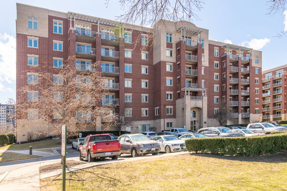 Front view of a multi-story apartment building with balconies.