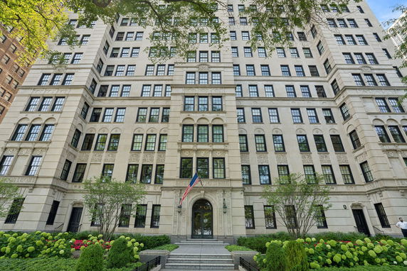 Front view of a multi-story residential building with elaborate architectural details and numerous windows.