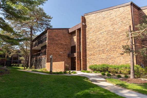 Front view of a multi-story brick apartment building.