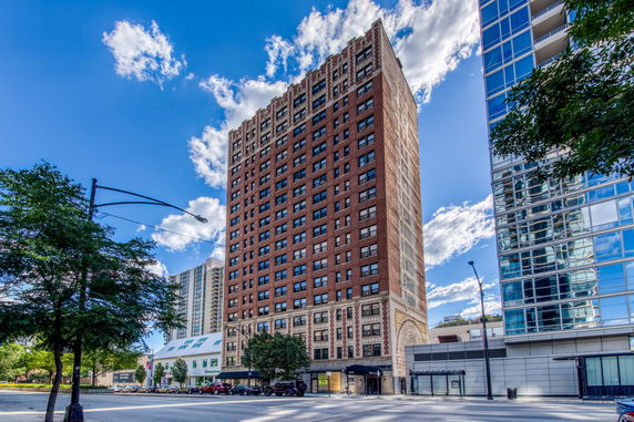 Front view of a high-rise building with a brick facade.