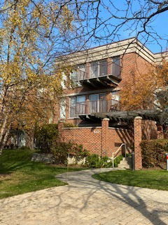 Front view of a brick residential building with balconies.