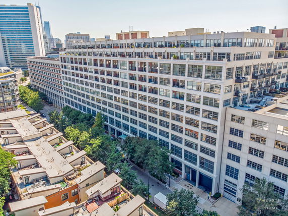 Front view of a large multi-story residential building with numerous windows and balconies.