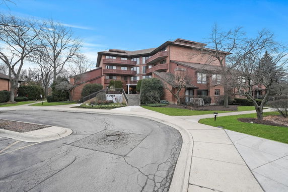 Front view of a multi-story building with a brick facade.