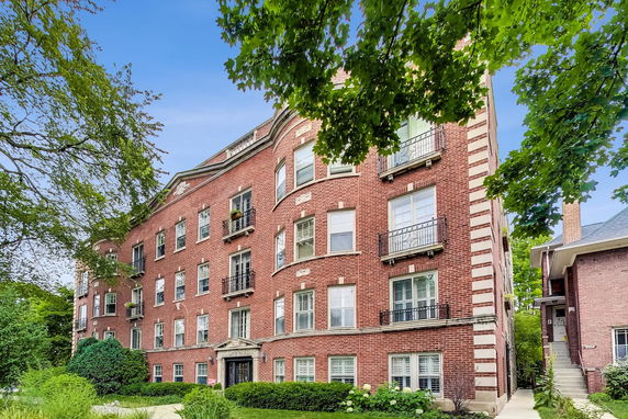 Front view of a multi-story brick apartment building.