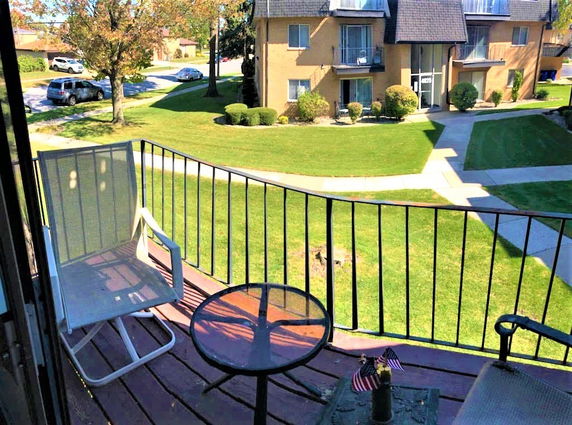 View of surrounding areas seen from a balcony in an apartment complex.