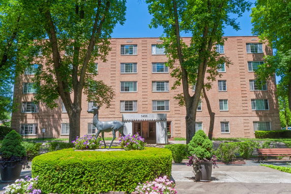 Front view of a multi-story brick apartment building.