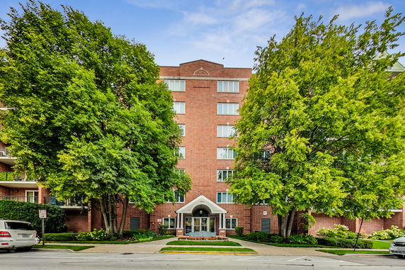 Front view of a mid-rise brick apartment building.
