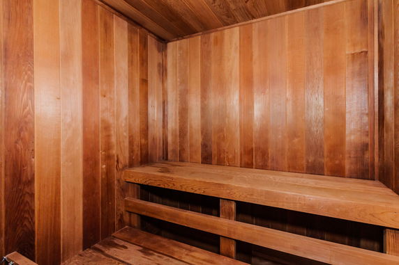 Interior view of a wooden sauna room with benches.