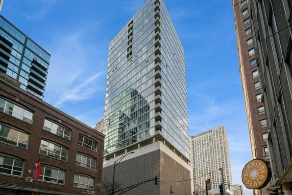 Front view of a modern glass high-rise building.