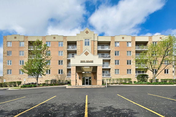 Front view of a multi-story residential building with a central entrance.
