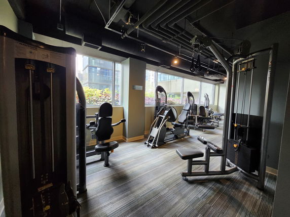 Interior view of a gym area with various exercise machines and equipment.