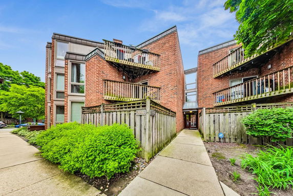 Front view of a multi-story brick building with balconies.