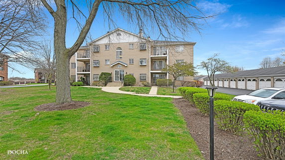 Front view of a multi-story residential building with balconies.