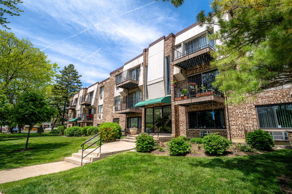 Front view of a multi-story apartment building with balconies.