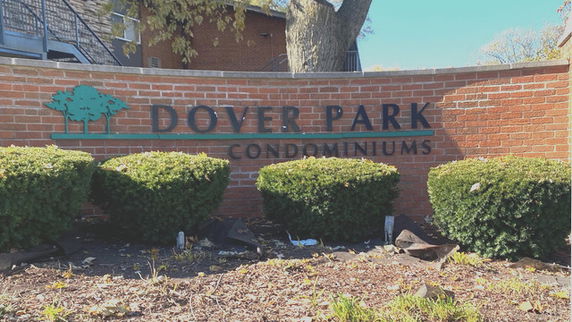 Front view of a brick wall with 'Dover Park Condominiums' signage.