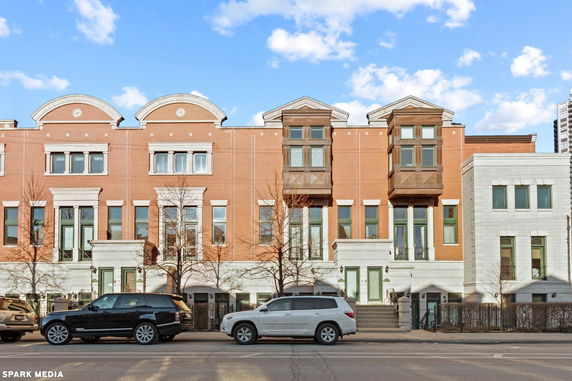 Front view of a row of multi-story brick townhouses