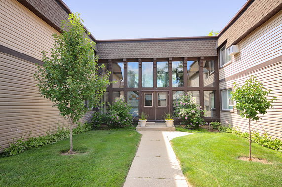 Front view of a two-story building with a central entrance and large windows.