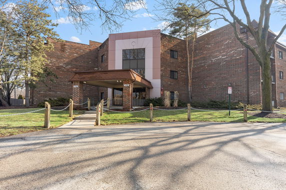 Front view of a brick building with a covered entrance.