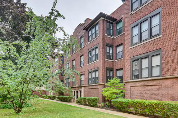 Front view of a multi-story brick apartment building.