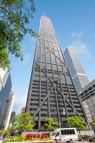 Front view of a tall skyscraper with a distinctive X-braced exterior.
