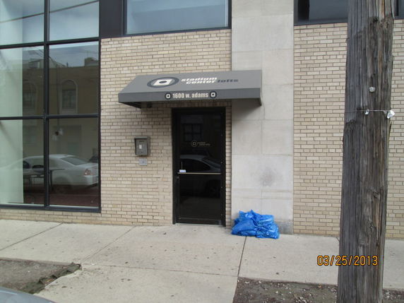 Front view of a building entrance with a glass door and a canopy.
