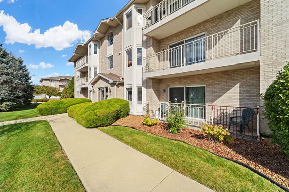 Front view of a multi-story residential building with balconies.
