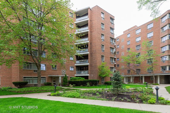 Front view of a multi-story brick apartment building.