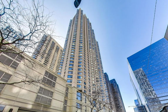 Front view of a tall high-rise building with numerous windows.