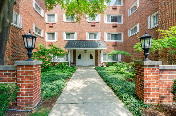 Front view of a brick multi-story building with a central entrance.