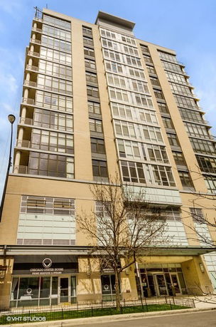 Front view of a multi-story building with large windows.