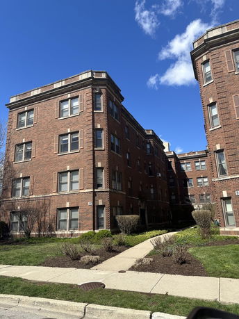Front view of a multi-story brick apartment building.