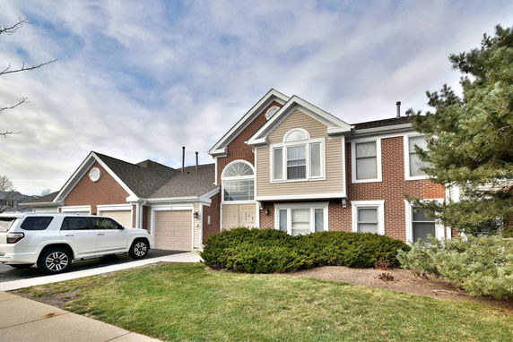 Front view of a two-story house with a double garage.