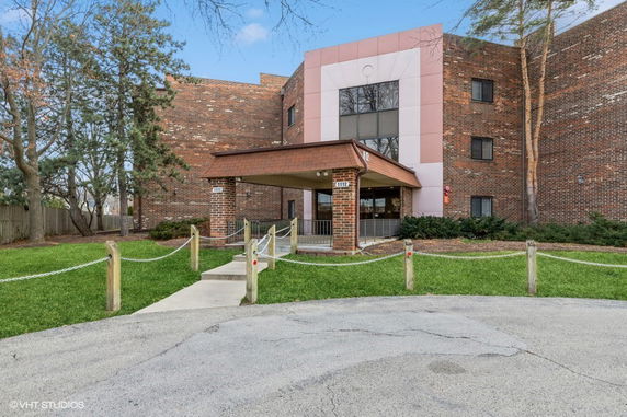 Front view of a multi-story brick building with an entrance canopy.