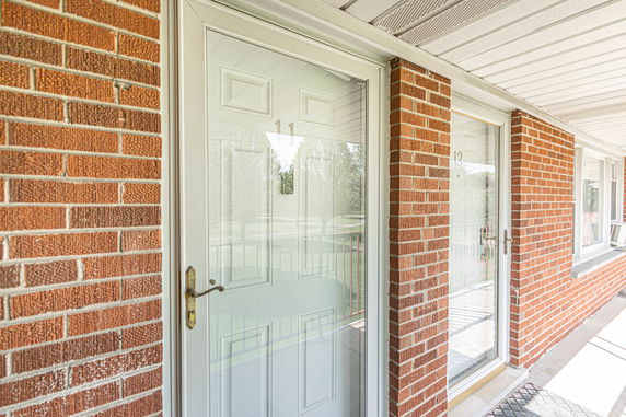 Front view of a building with a brick exterior and white doors.