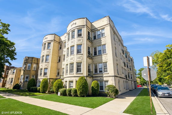 Front view of a multi-story brick apartment building.