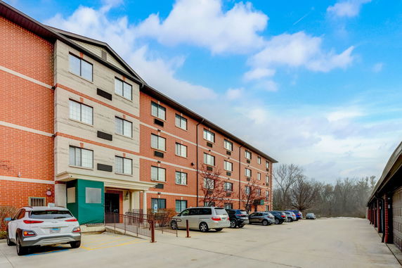 Front view of a multi-story building with a parking area.