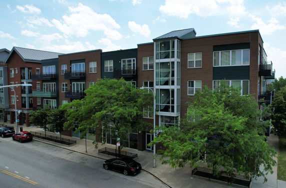 Front view of a multi-story apartment building with balconies.