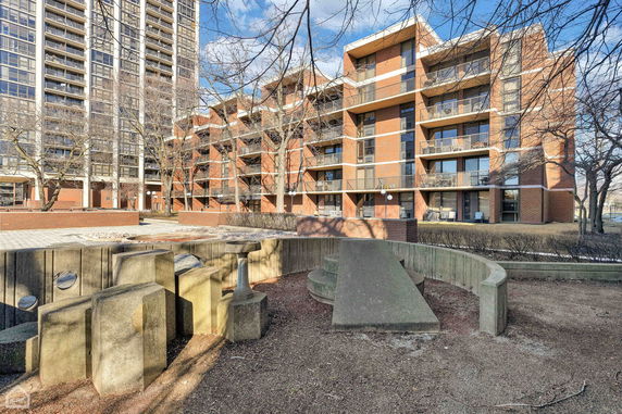 Front view of a multi-story apartment building with balconies.