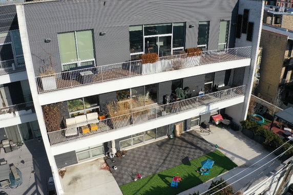 Front view of a multi-story building with balconies.