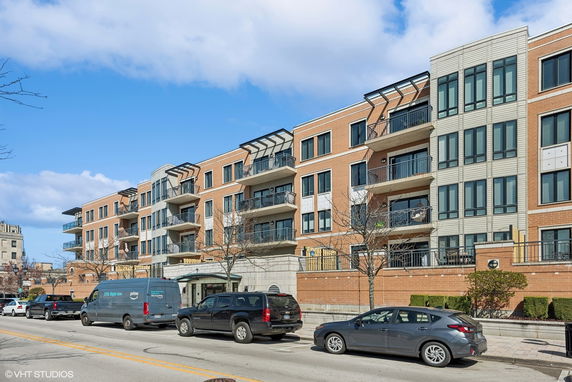 Front view of a multi-story residential building with balconies.