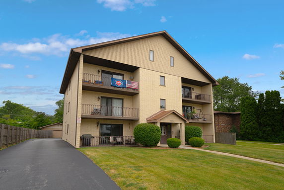 Front view of a multi-story residential building with balconies.