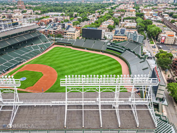 Panoramic view of a large baseball stadium with green seating and a well-maintained field.