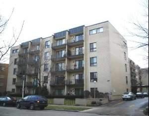 Front view of a multi-story apartment building with balconies.