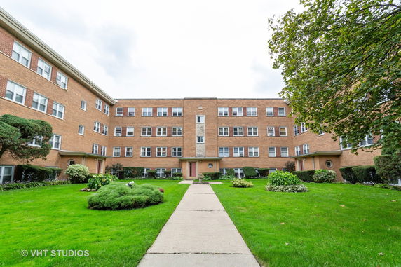 Front view of a multi-story brick apartment building