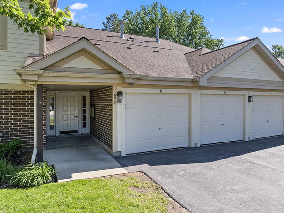 Front view of a townhouse with multiple garages.